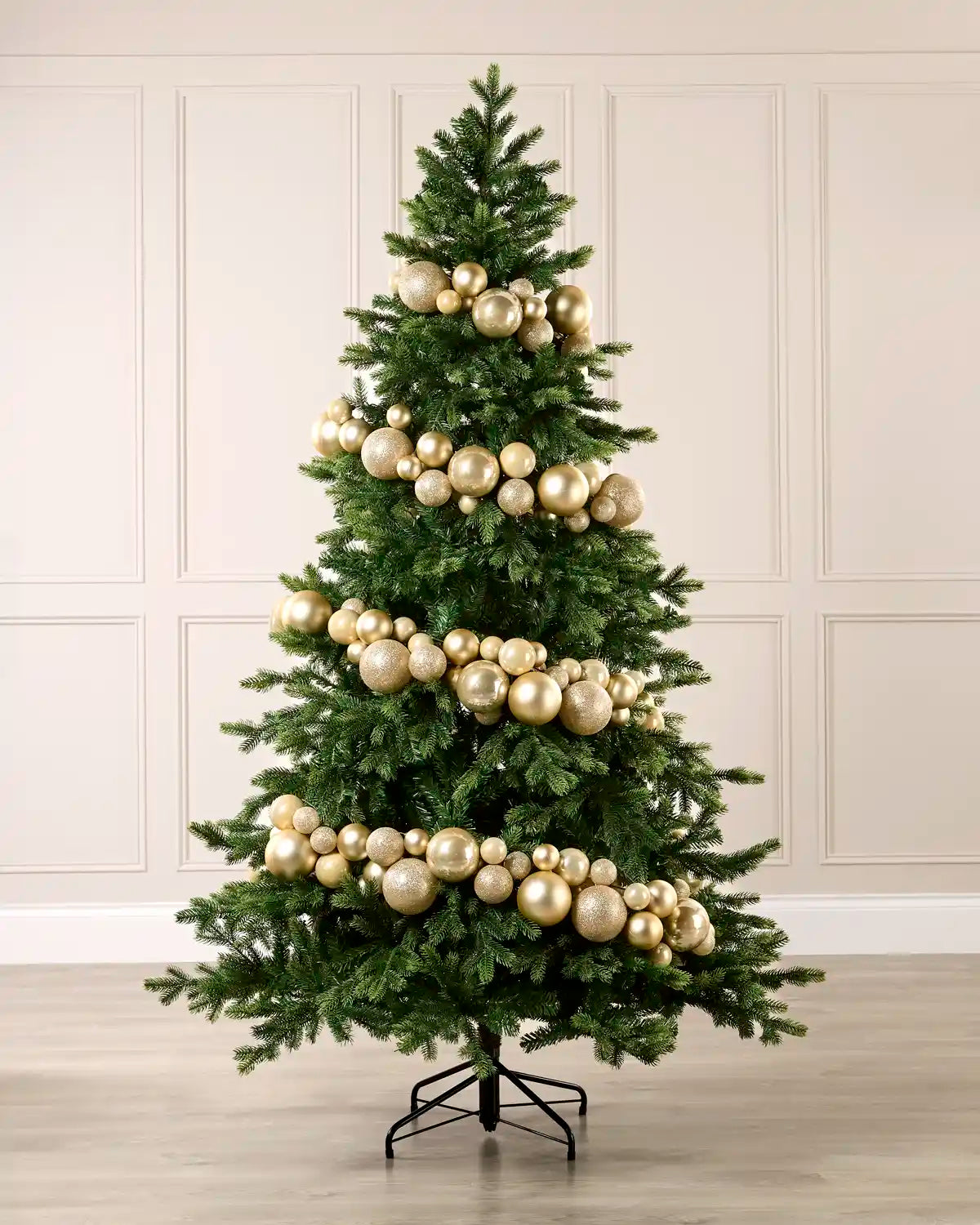 Latte bauble garland wrapped around a green Christmas tree with shiny, matt and glitter baubles.
