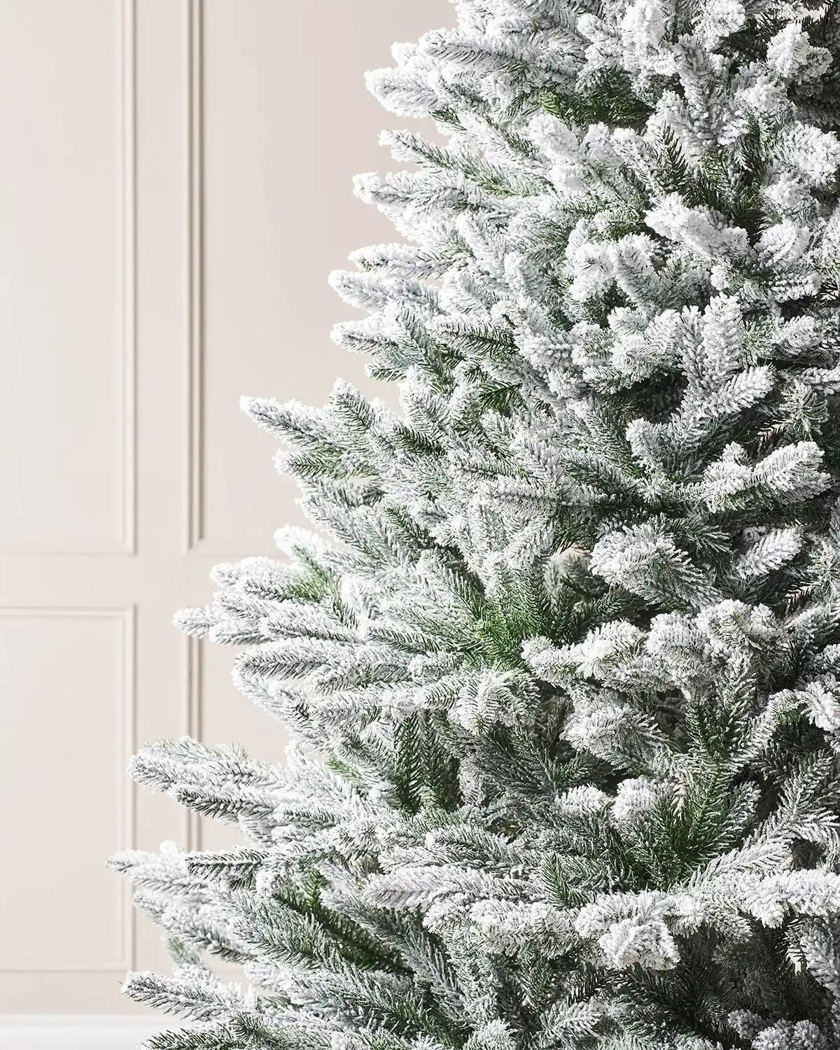 Close up of the PVC and PE tips on a Luxury Snow Flocked Christmas Tree, 6 ft on a Panel textured background
