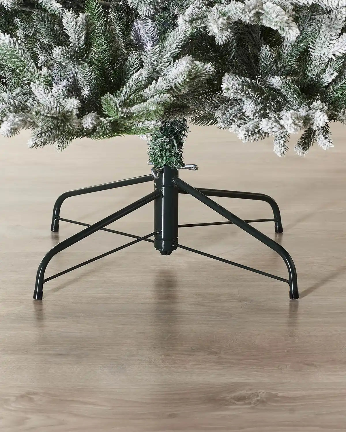 Close up of the snow flocked PVC and PE tips, Black tree stand and the base of the tree on Luxury Snow Flocked Christmas Tree, 6 ft