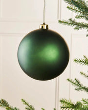 Matt Sage green oversized 15cm Christmas bauble on a Christmas tree branch