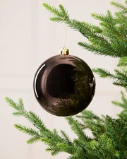 Mocha 15 cm oversized Shiny shatterproof bauble hanging on a Christmas tree with a gold cap and matching string.
