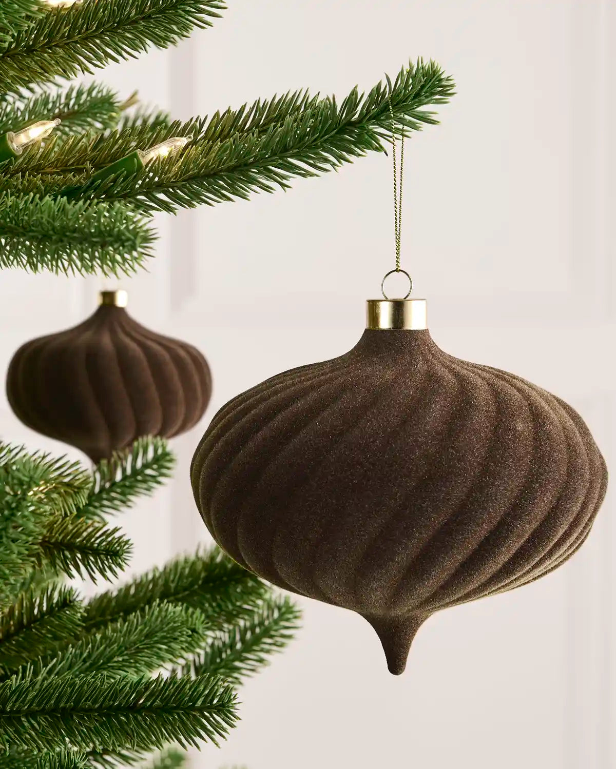 Mocha 15 cm oversized velvet Spiral bauble displayed on a Christmas tree with coordinating ornaments.
