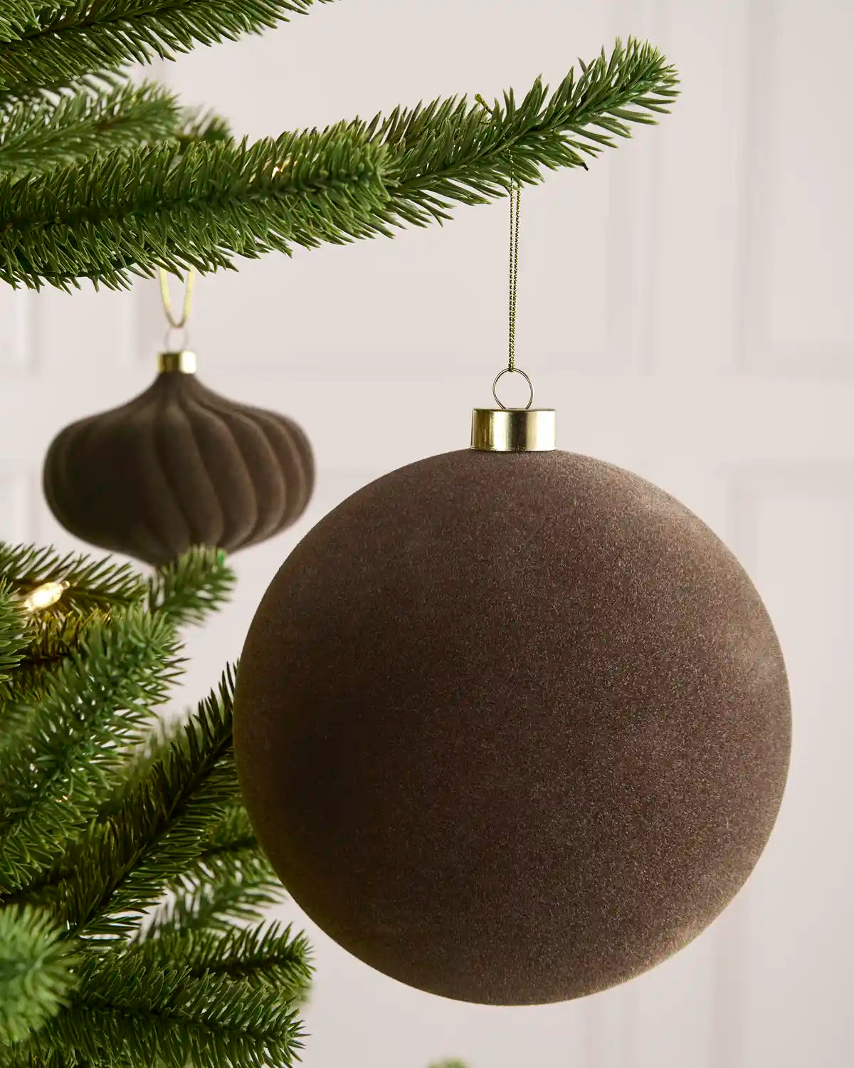 Mocha 15 cm oversized velvet Traditional bauble displayed on a Christmas tree with coordinating ornaments.

