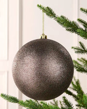 Mocha 20 cm oversized Glitter shatterproof bauble hanging on a Christmas tree with a gold cap and matching string.
