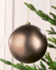 Mocha 20 cm oversized Matt shatterproof bauble hanging on a Christmas tree with a gold cap and matching string.
