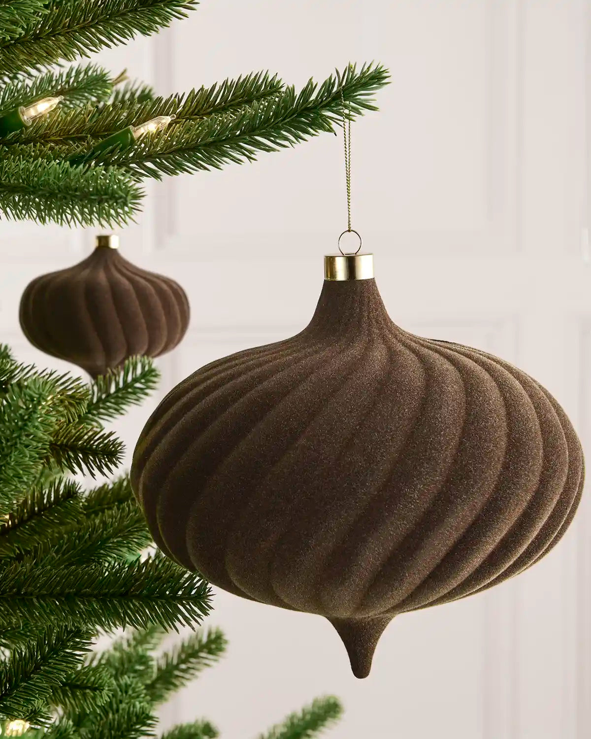 Mocha 20 cm oversized velvet Spiral bauble displayed on a Christmas tree with coordinating ornaments.
