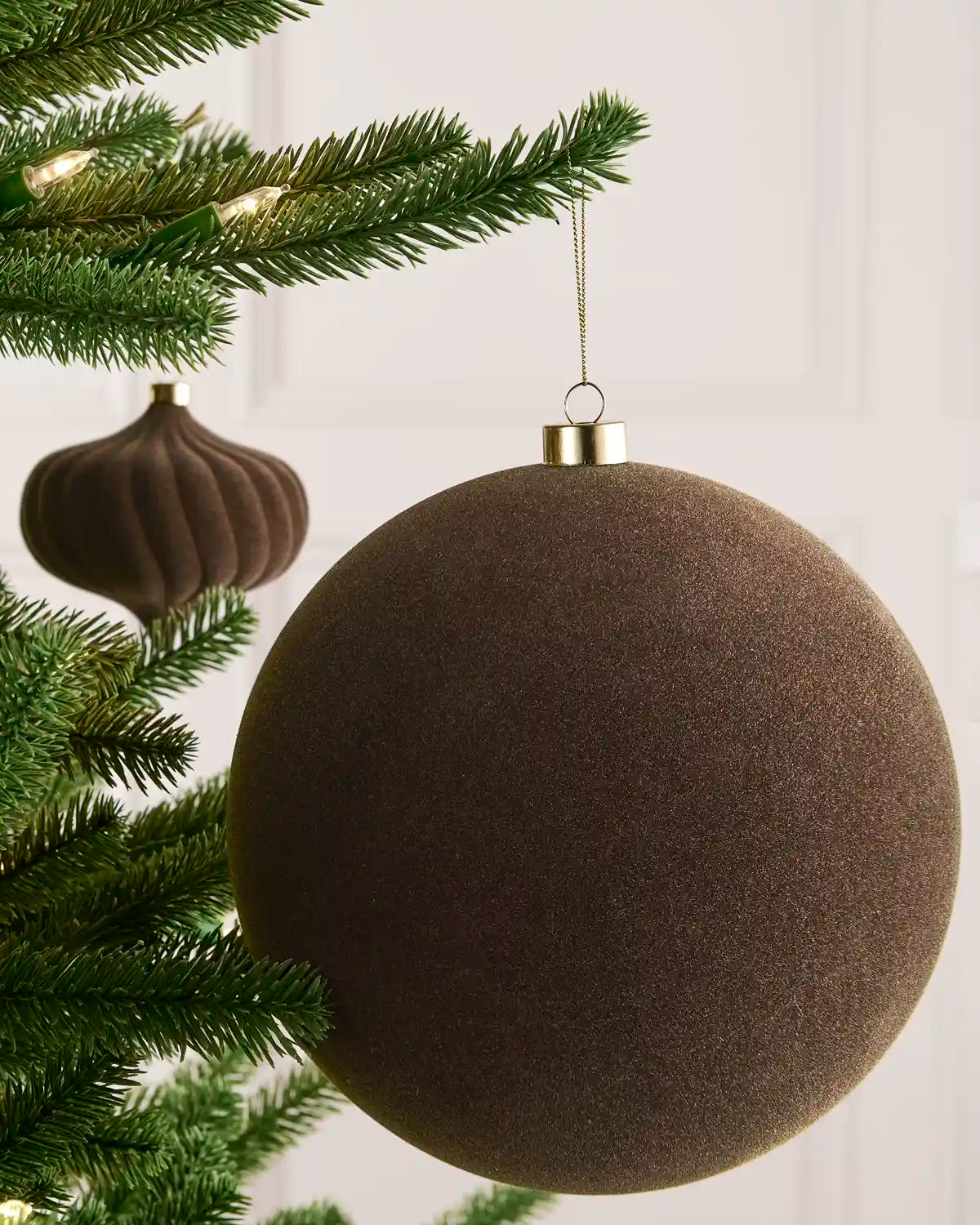 Mocha 20 cm oversized velvet Traditional bauble displayed on a Christmas tree with coordinating ornaments.

