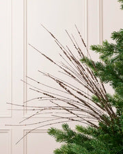 Mocha Glitter Wispy Spray with long, slender glitter-covered stems arranged in a fan shape on a Christmas tree
