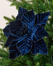 Navy Blue Poinsettia with a glitter border on a Green Christmas tree against and cream panel background
