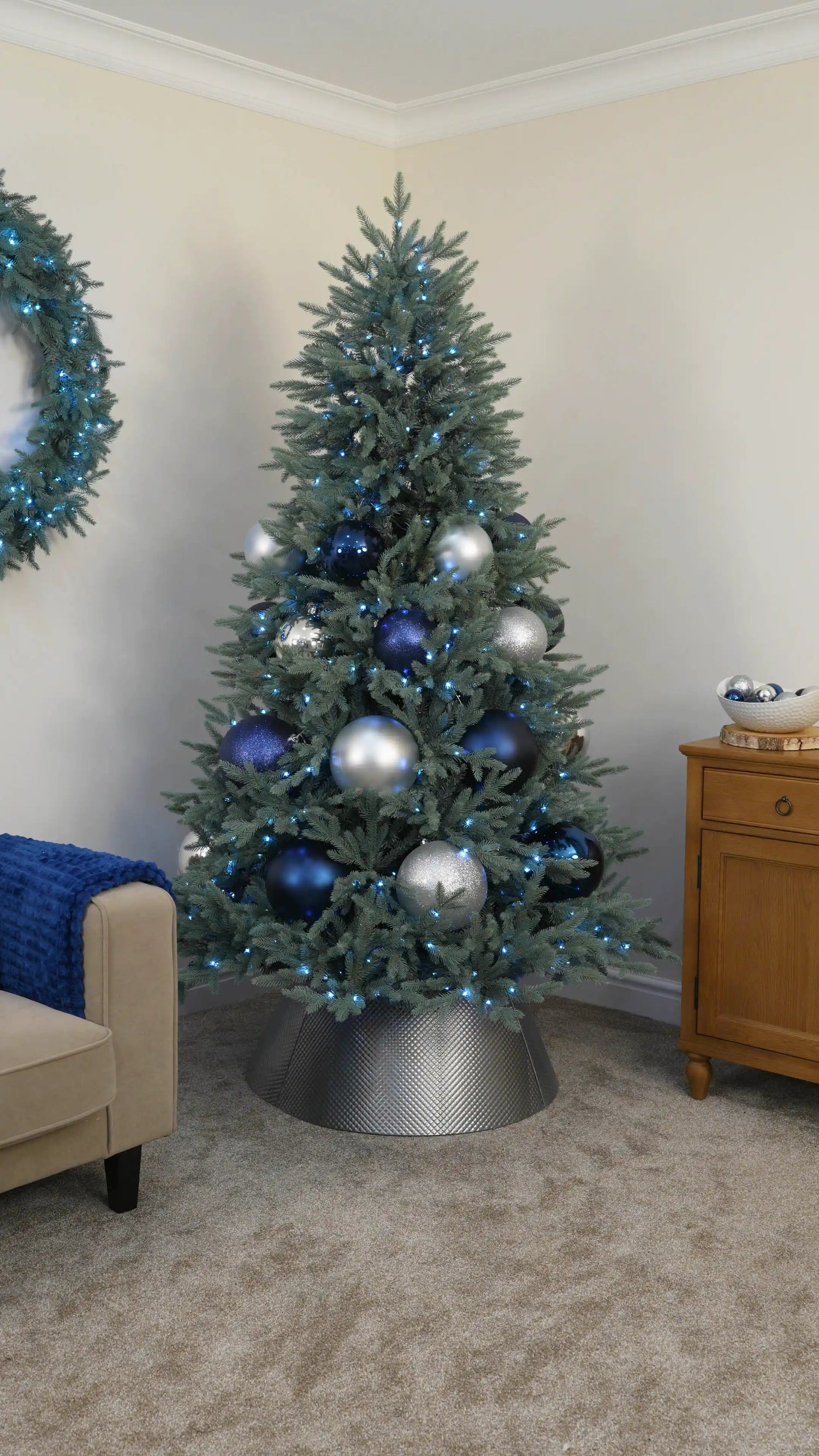 Layer Smaller Navy and Silver Baubles Throughout the Tree