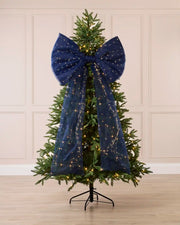 Navy blue pre-lit Christmas bow displayed on a decorated Christmas tree.