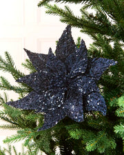 Navy sequin poinsettia on a Christmas Tree against a light background