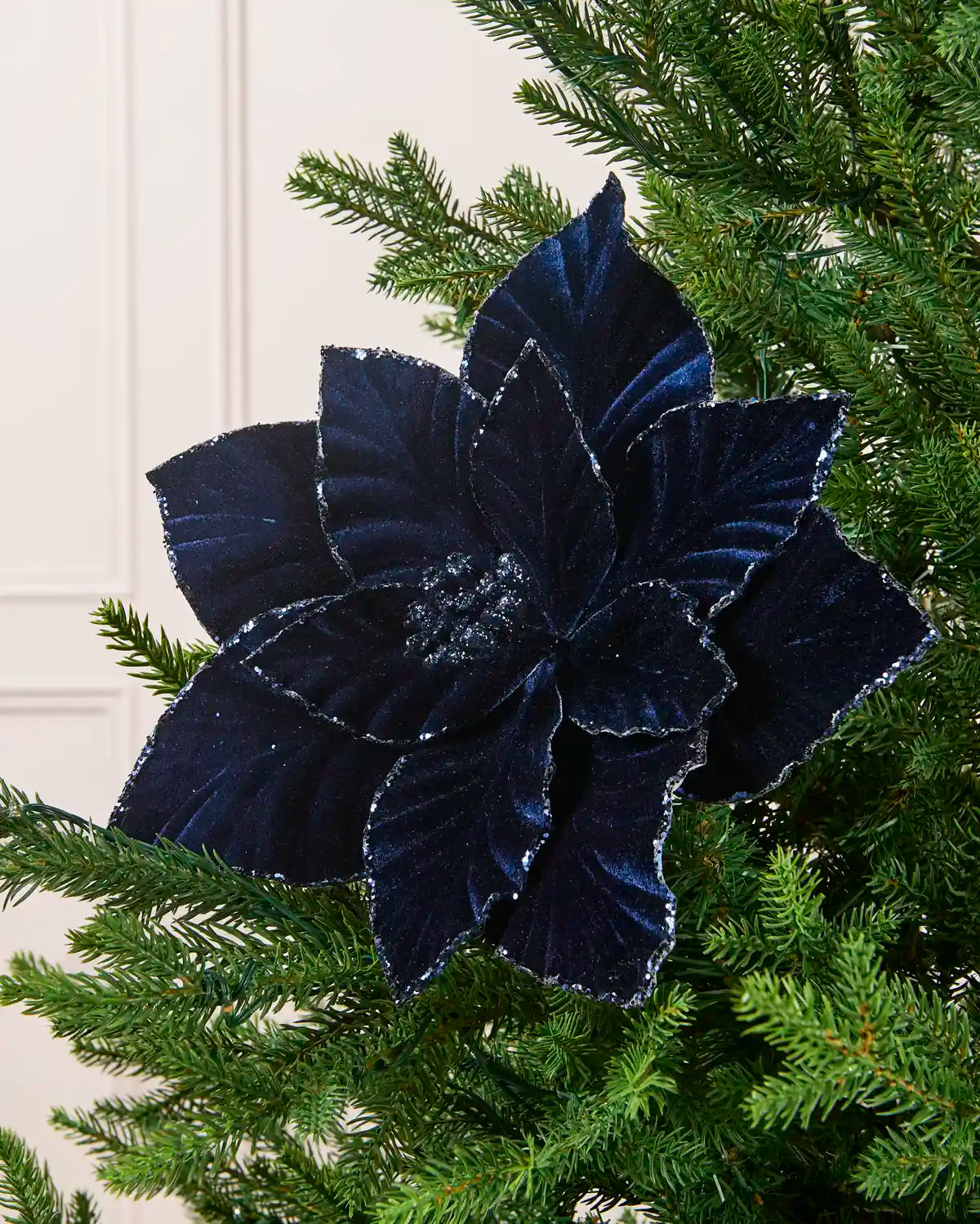 Navy  velvet artificial poinsettia with glittered edges and a glittered center
