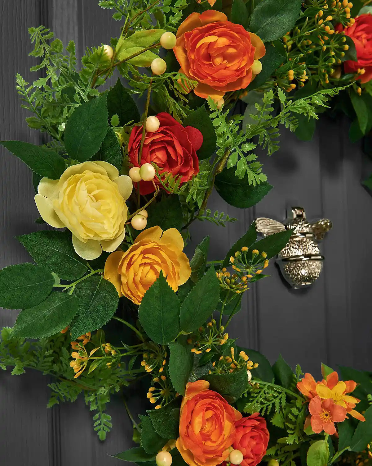 Orange, 28 Inch, Artificial Floral Rose Spring Wreath on a Black door, close up shot.