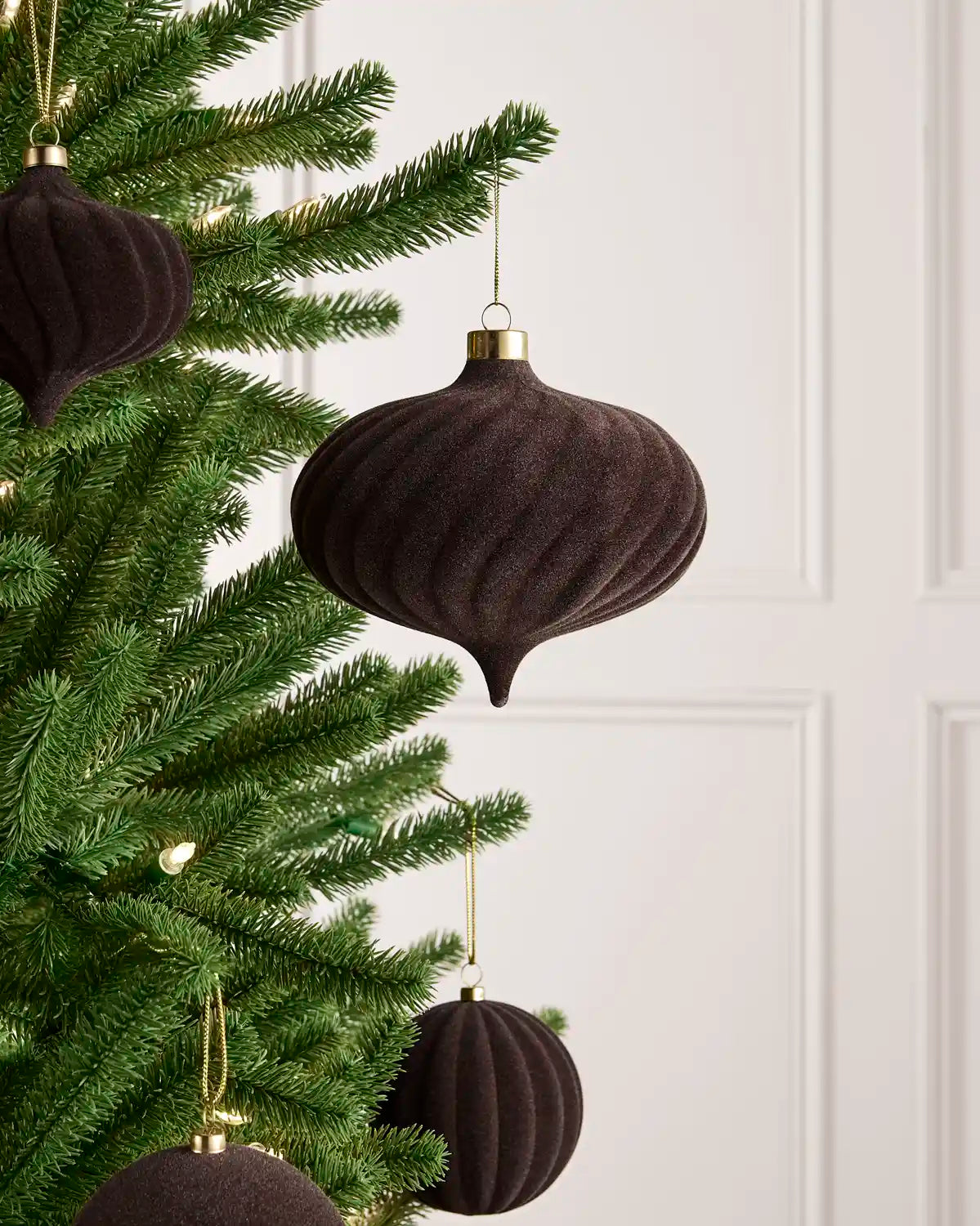 Oversized 15 cm Espresso velvet Spiral bauble styled among matching decorations on a Christmas tree.

