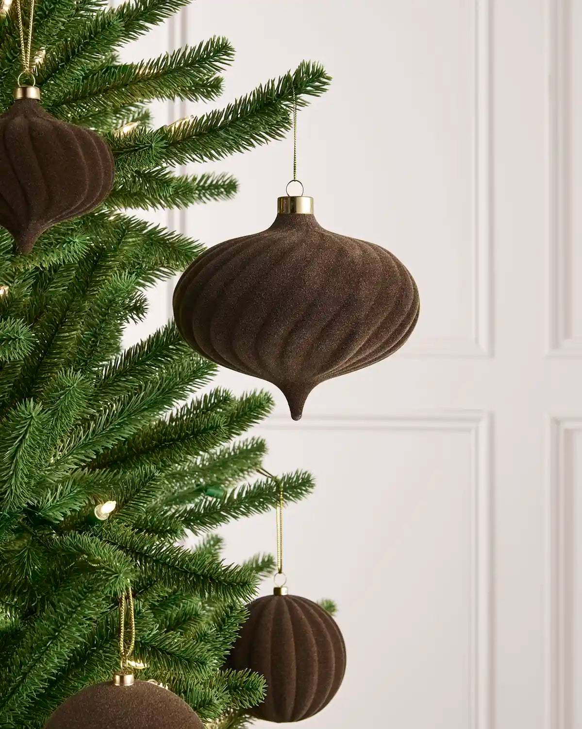 Oversized 15 cm Mocha velvet Spiral bauble styled among matching decorations on a Christmas tree.
