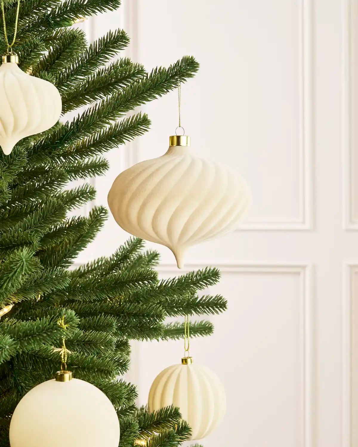 Oversized 15 cm latte velvet Spiral bauble styled among matching decorations on a Christmas tree.
