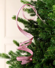 Pink Glitter Spiral Swirl Pick hanging from Christmas tree branch with cream background
