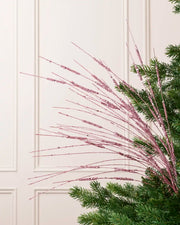 Pink Glitter Wispy Spray with long, slender glitter-covered stems arranged in a fan shape on a Christmas tree
