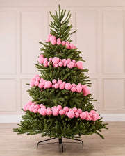 Pink Velvet Bauble Garland decorating a Christmas tree, featuring pink velvet baubles arranged along the garland.