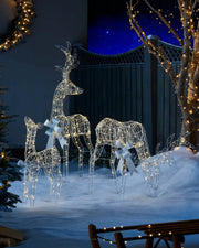 Pre-Lit 3D Reindeer Family, Silhouette, 135 cm in a snowy garden with Trees and lights at night time