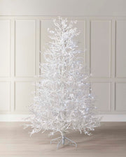 Minimalistic pre-lit white Arctic Ice Twig Christmas tree with snow-flocked PE/PVC branches, glowing with bright white LED lights against a neutral wall—crafted for easy setup and timeless winter charm.
