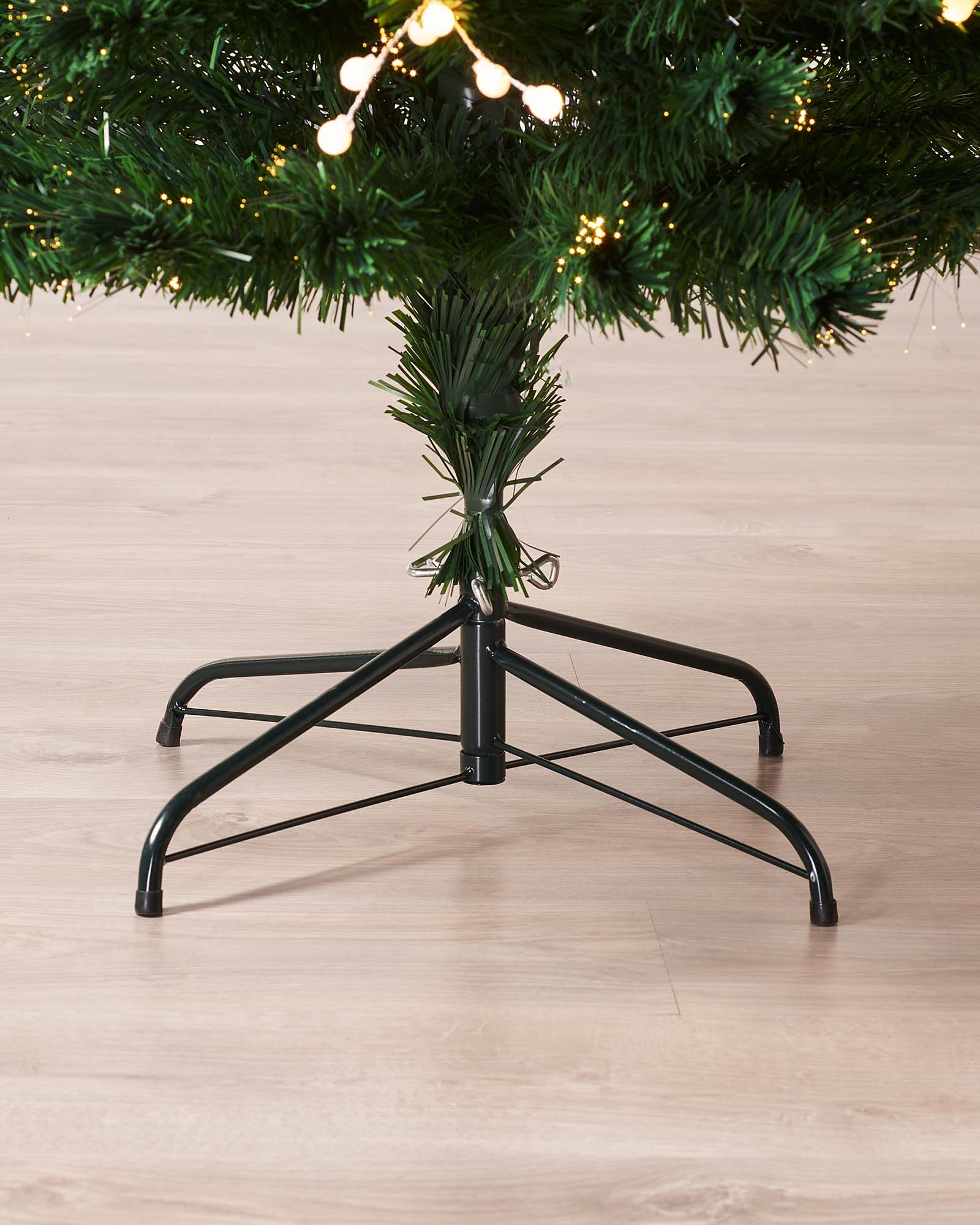 7-foot artificial Christmas tree with green fibre optic branches, white berry clusters, and warm white LED lights, topped with a glowing star—pre-lit and naturalistic, creating a rustic yet striking festive centerpiece against a plain background.