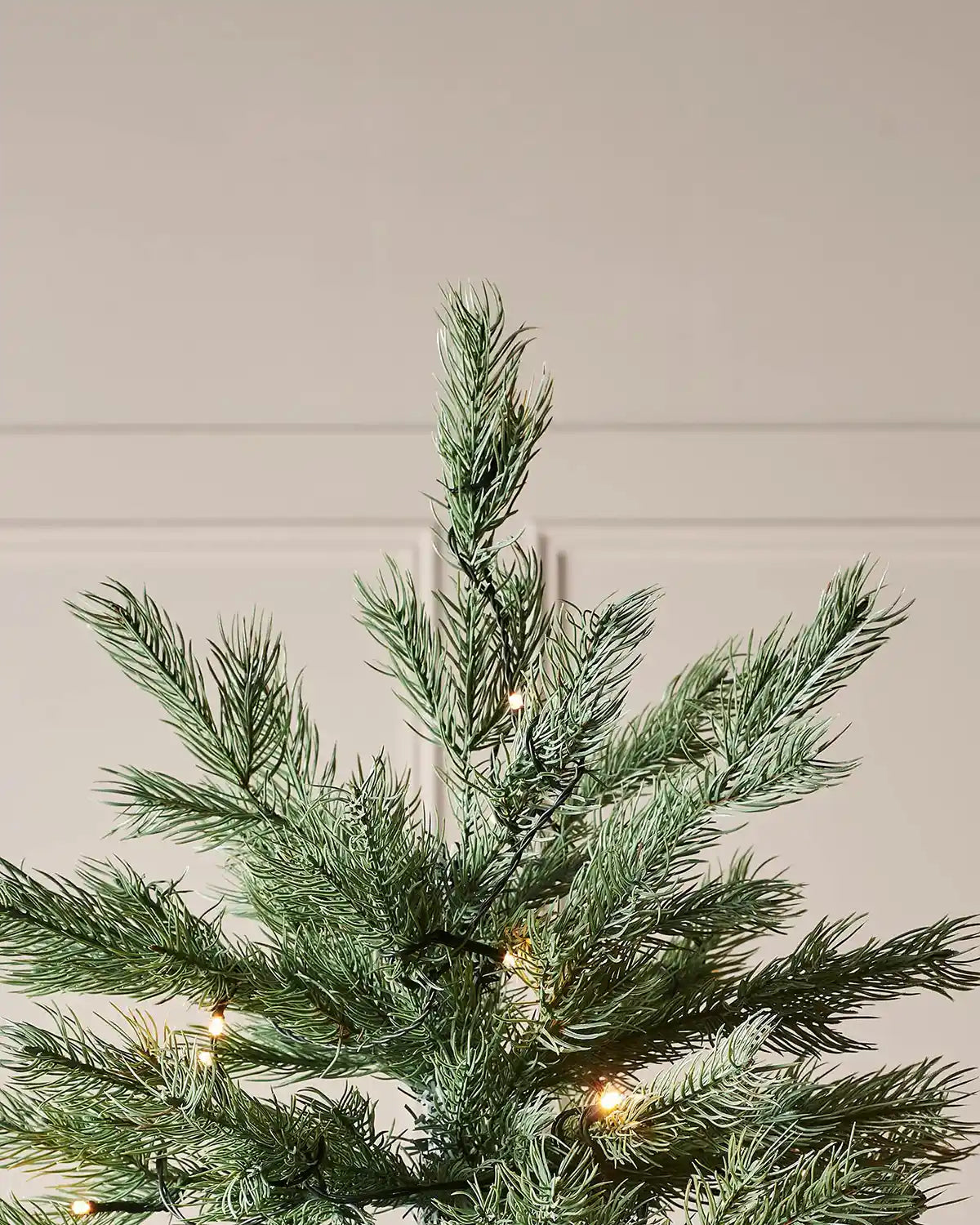 Pre-Lit Colorado Blue Spruce Christmas Tree with lights, 7 ft close up of top of tree with tips and lights 