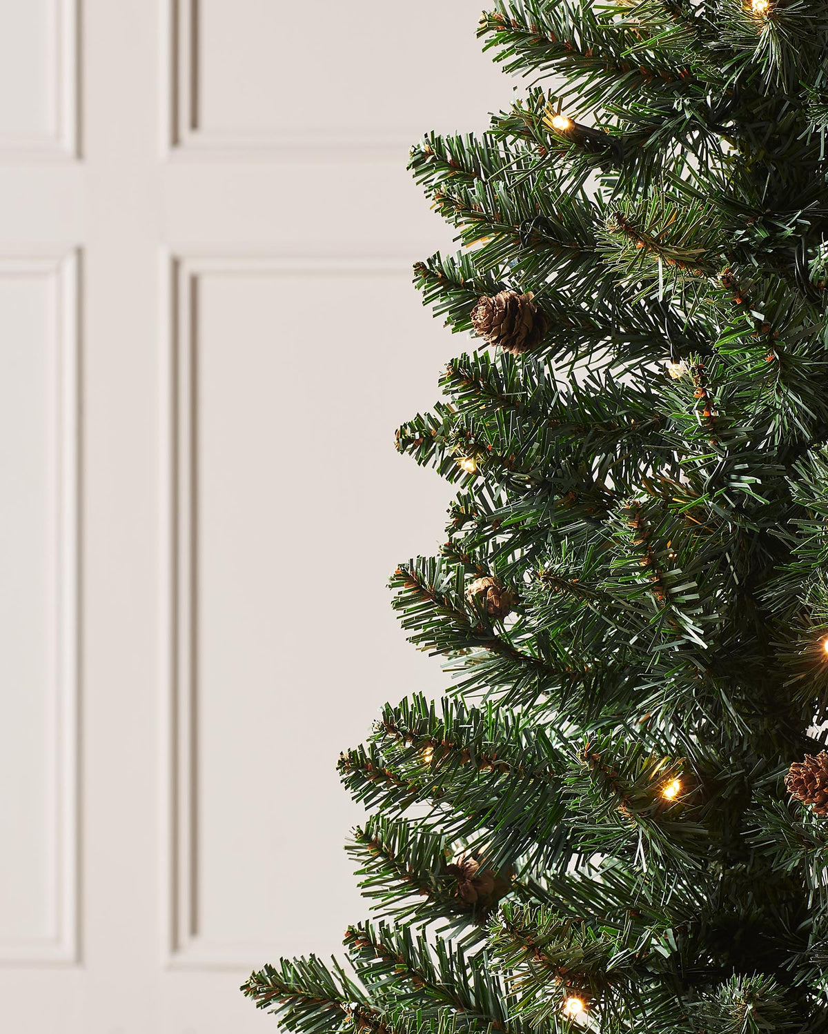 Pre-lit 46 cm (18 inch) potted Craford Pine Christmas tree with 150 lush PVC tips and 80 warm white LED lights—compact, elegant, and glowing with festive warmth, perfect for mantles, tabletops, or cosy indoor corners.