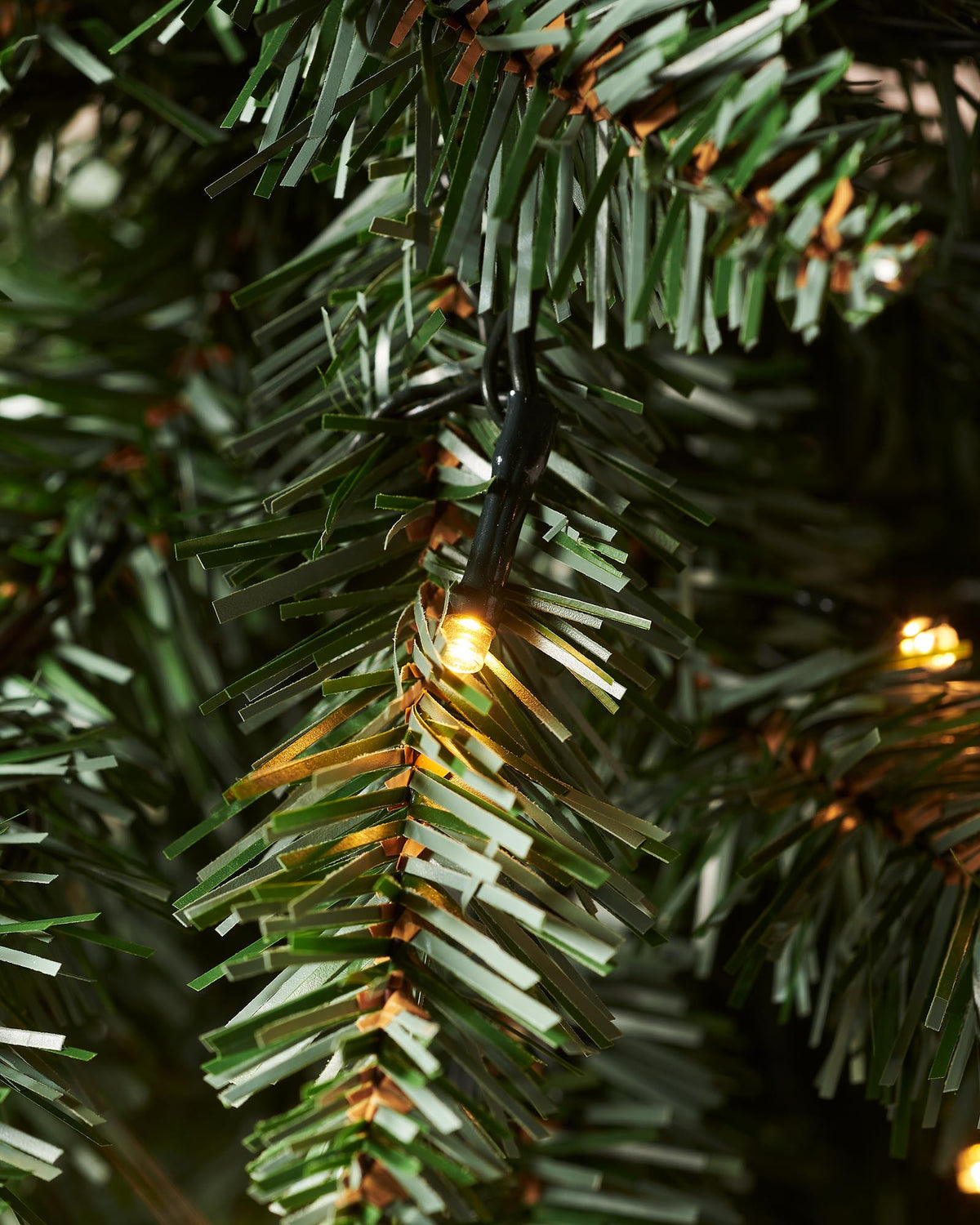 Pre-lit 46 cm (18 inch) potted Craford Pine Christmas tree with 150 lush PVC tips and 80 warm white LED lights—compact, elegant, and glowing with festive warmth, perfect for mantles, tabletops, or cosy indoor corners.