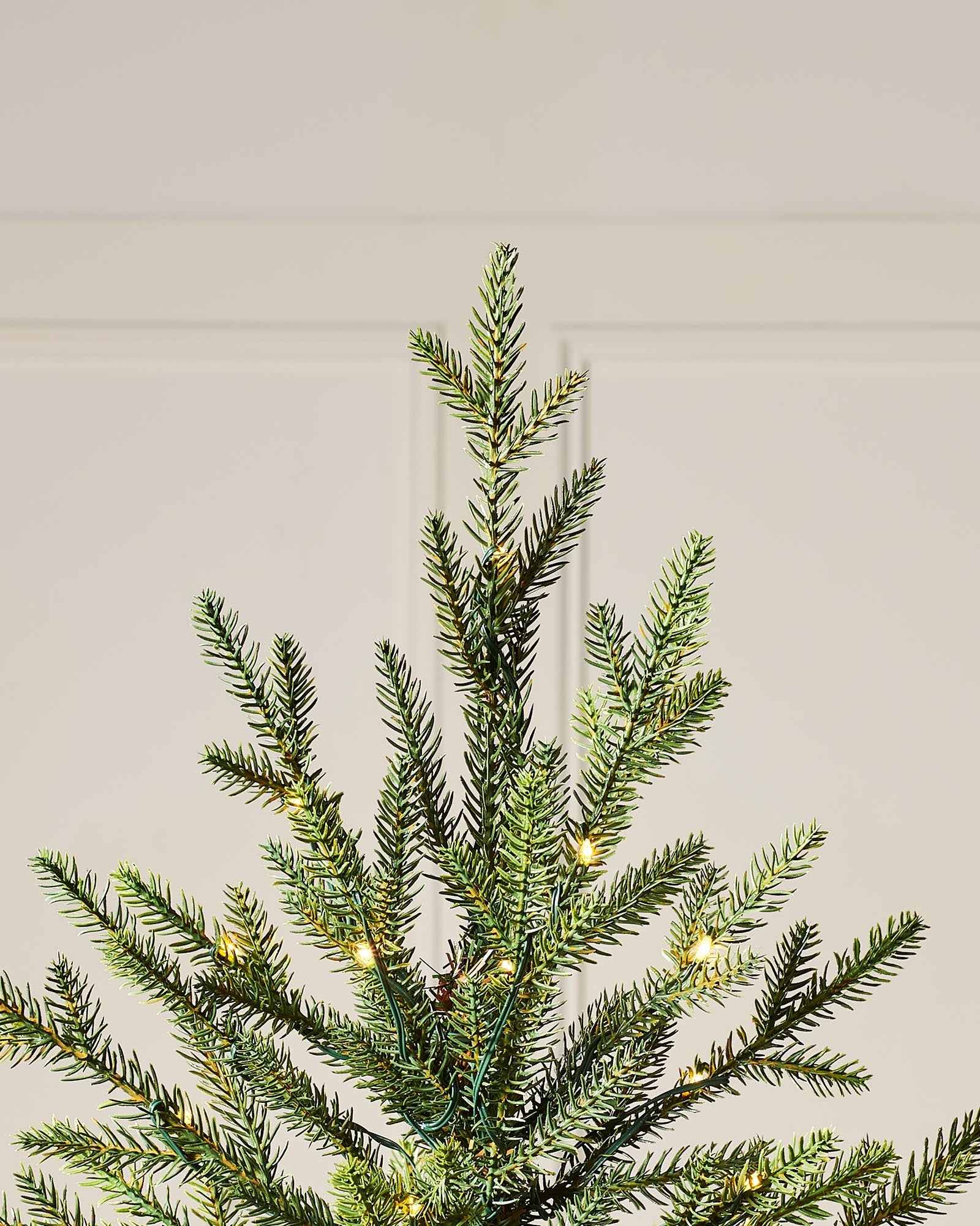 Pre-lit artificial Douglas Fir Christmas tree with warm white copper wire LED lights, available in green or snow-flocked finish, featuring lifelike PE and PVC branches and 8 lighting functions, displayed against a plain background.