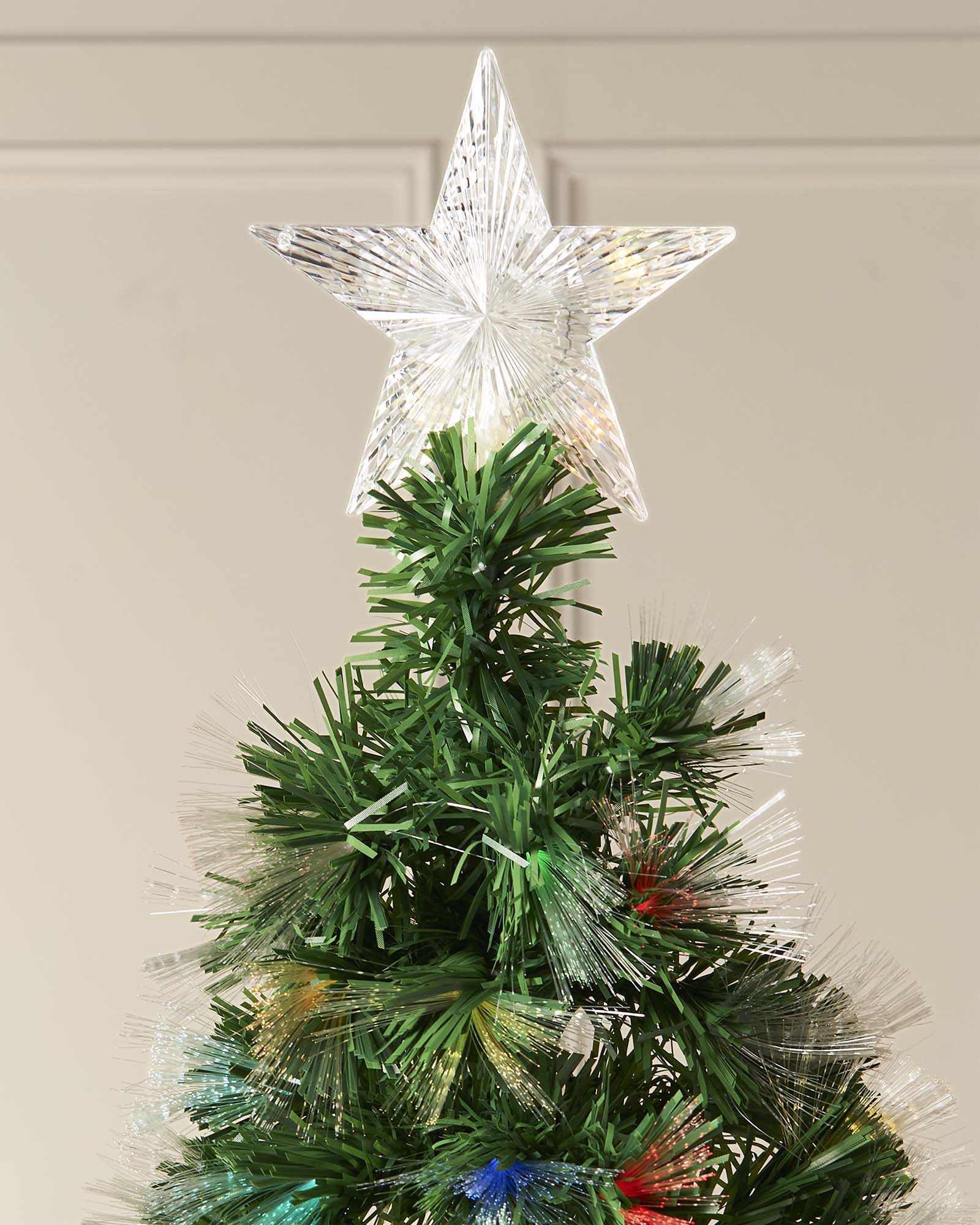 A pre-lit fiber optic Christmas tree with a tree topper, standing upright against a plain background.