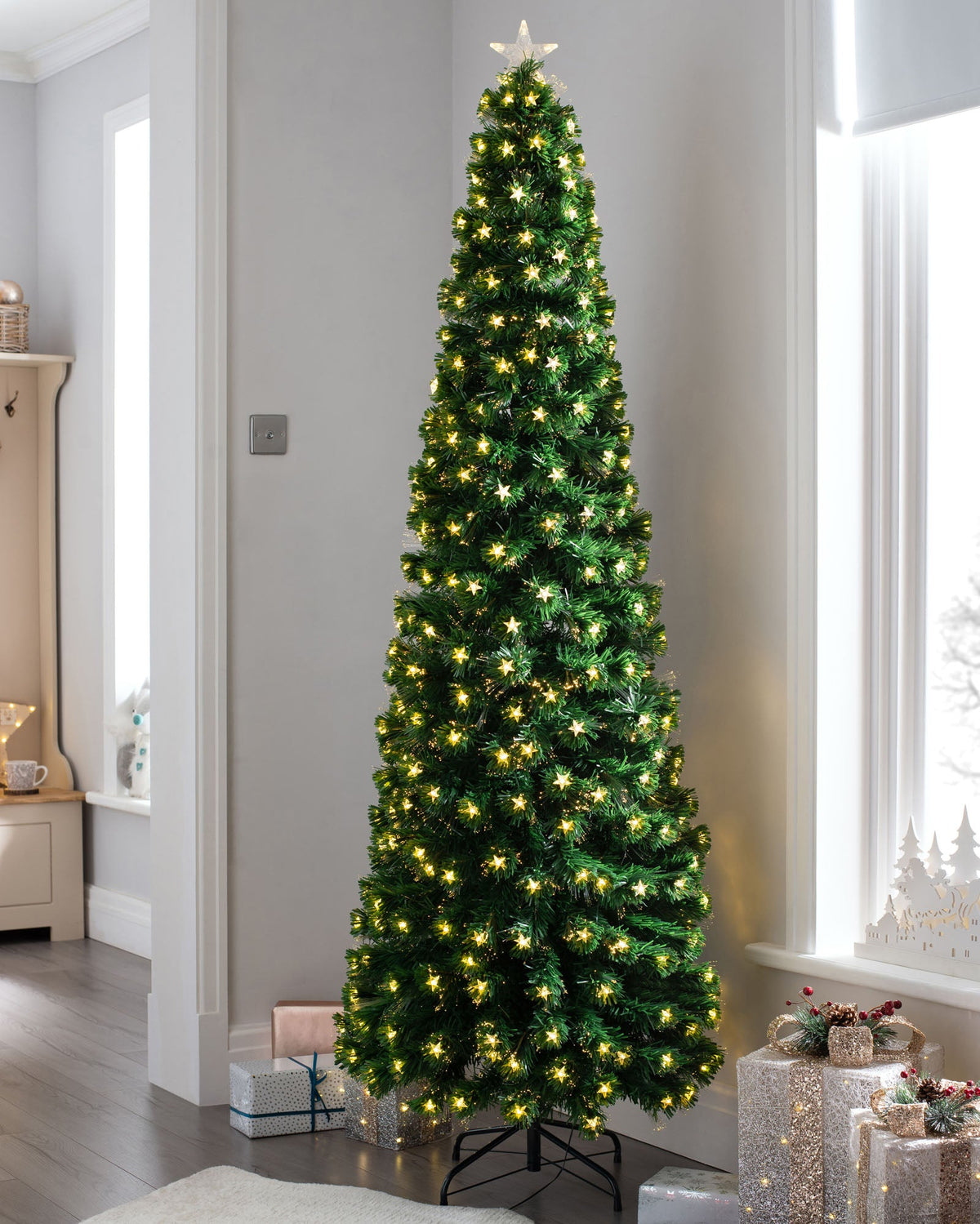 7-foot pre-lit fibre optic pencil Christmas tree with 290 fibre optic tips, 294 warm white LEDs, and an LED star topper, featuring a slim 70 cm diameter and displayed indoors.