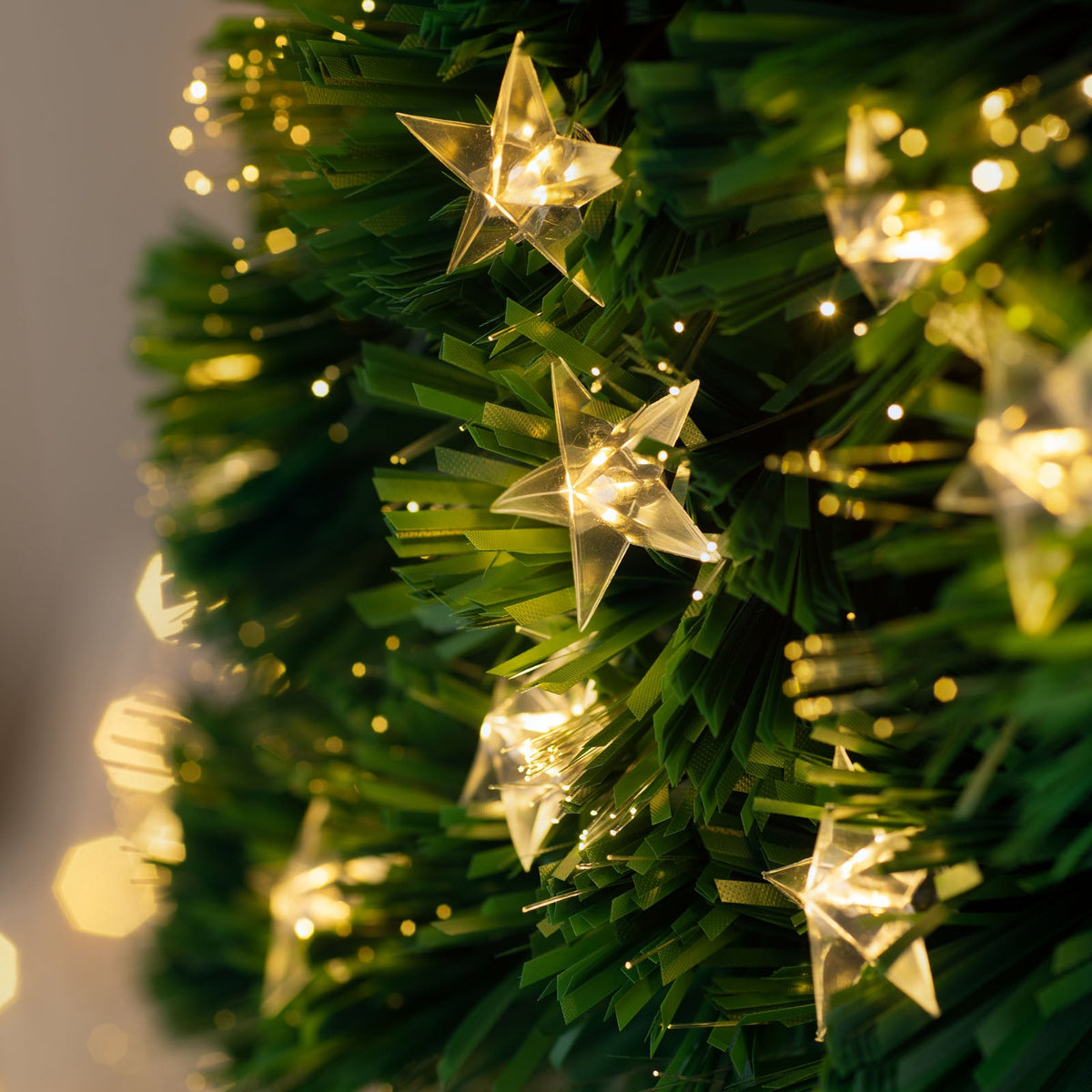 7-foot pre-lit fibre optic pencil Christmas tree with 290 fibre optic tips, 294 warm white LEDs, and an LED star topper, featuring a slim 70 cm diameter and displayed indoors.
