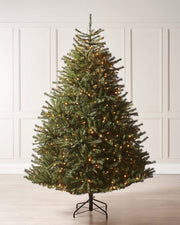 Pre-lit Foxtail Pine Christmas tree with warm white LED lights and V-cut tips, featuring a realistic tinsel bark effect, displayed against a plain background.