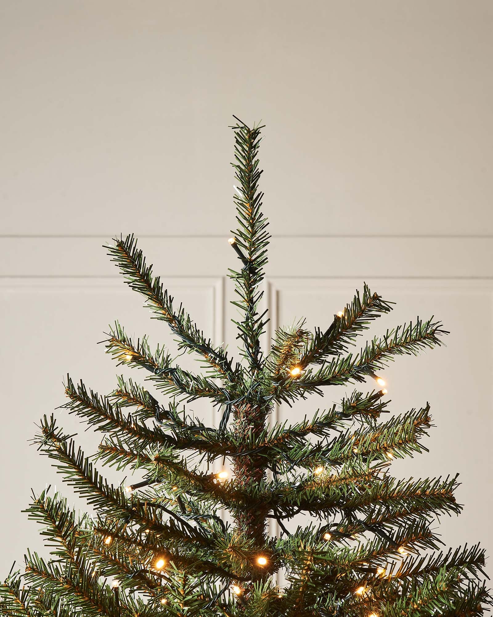 Pre-lit Foxtail Pine Christmas tree with warm white LED lights and V-cut tips, featuring a realistic tinsel bark effect, displayed against a plain background.
