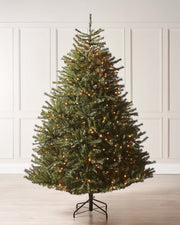 Pre-lit Foxtail Pine Christmas tree with warm white LED lights and V-cut tips, featuring a realistic tinsel bark effect, displayed against a plain background.