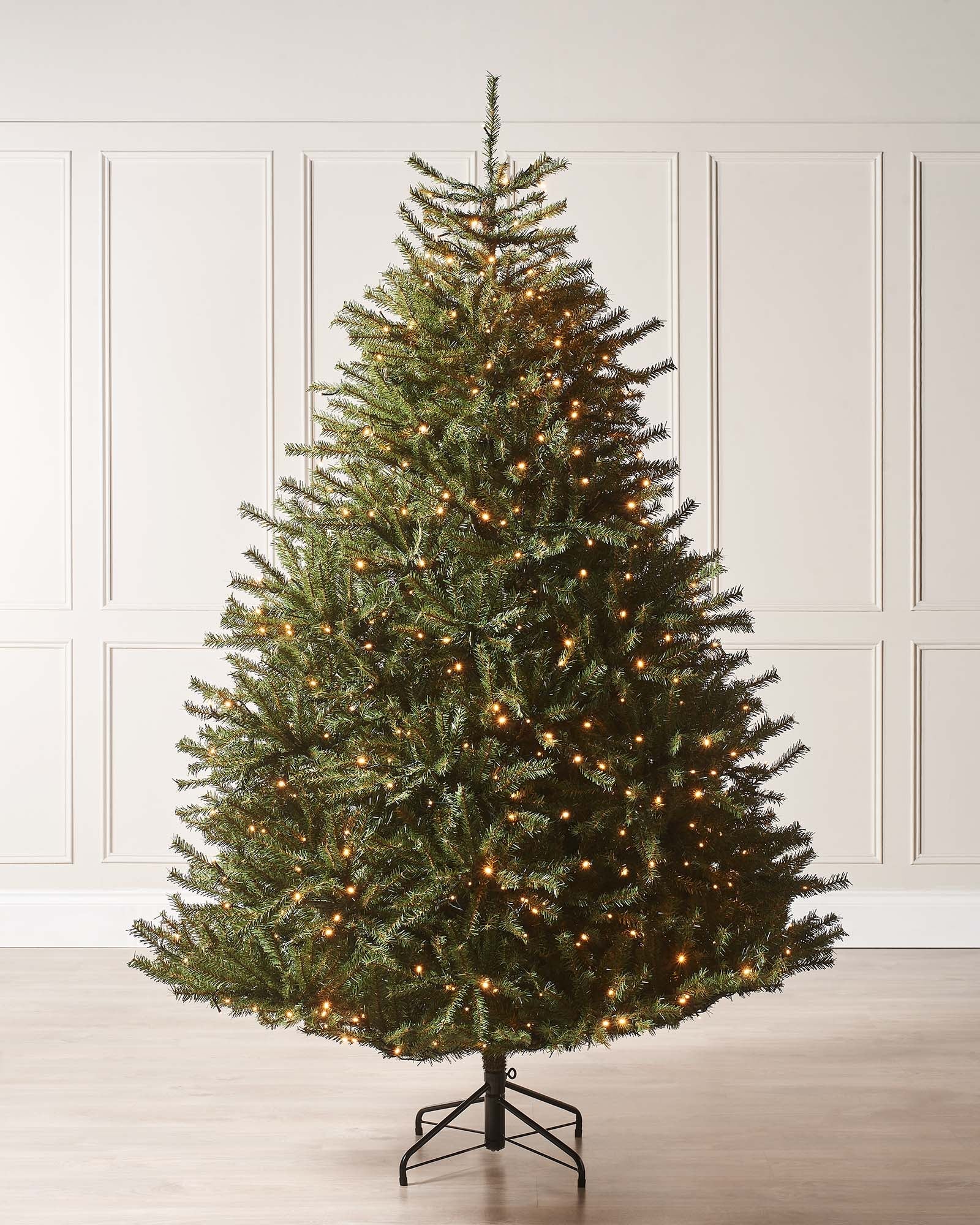 Pre-lit Foxtail Pine Christmas tree with warm white LED lights and V-cut tips, featuring a realistic tinsel bark effect, displayed against a plain background.