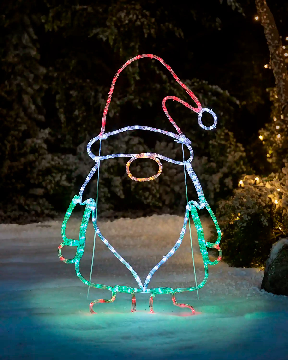 Pre-Lit Gonk Rope Light Silhouette with green, white, red and Gold LEDs throughout. Held up with a stand in a garden setting