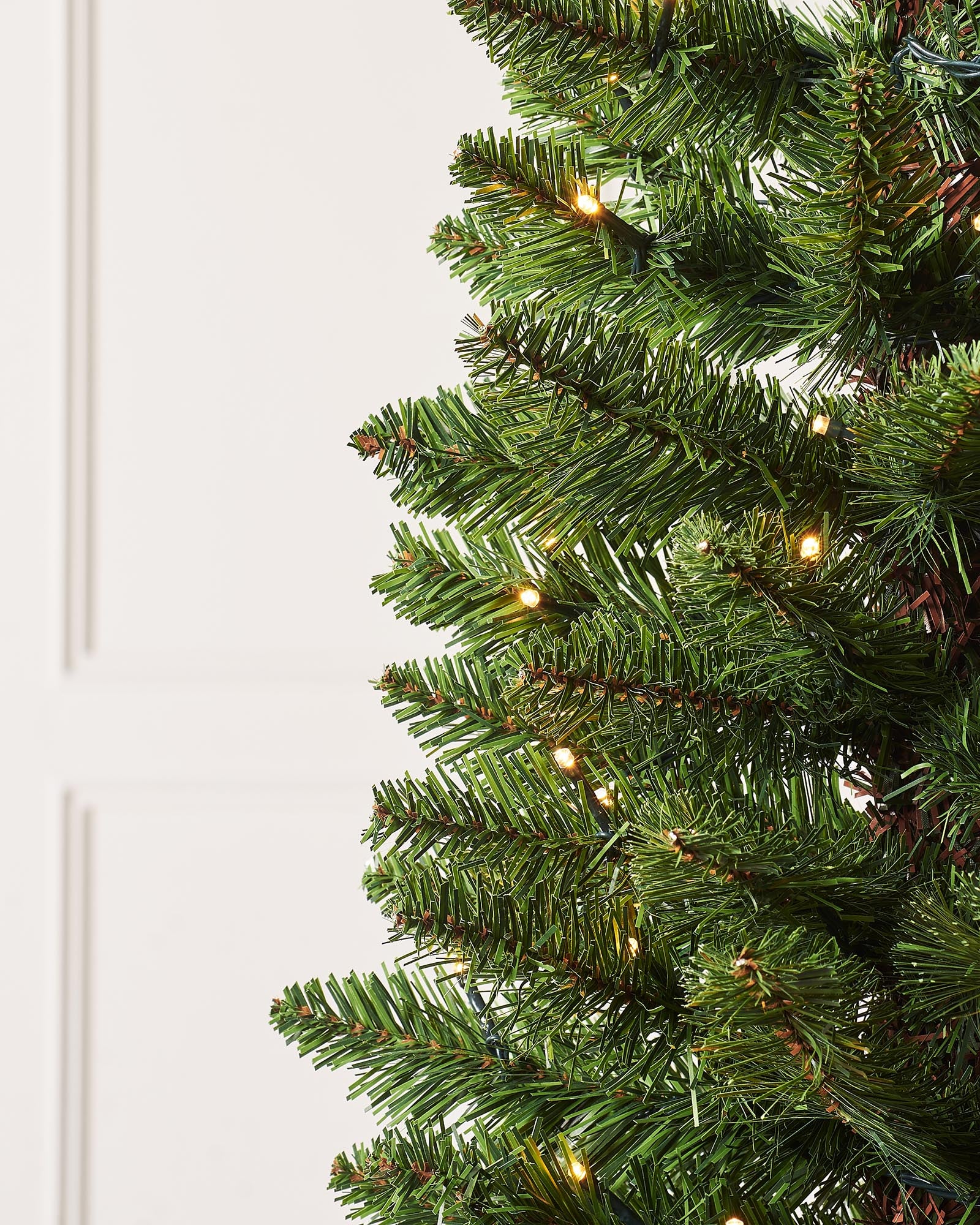 Pre-lit green pencil Christmas tree with slender shape, 400 mixed PE and PVC tips, and warm white LED lights, displayed indoors against a white background.