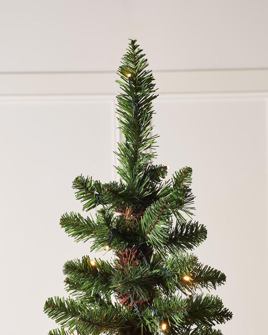 Pre-lit green pencil Christmas tree with slender shape, 400 mixed PE and PVC tips, and warm white LED lights, displayed indoors against a white background.
