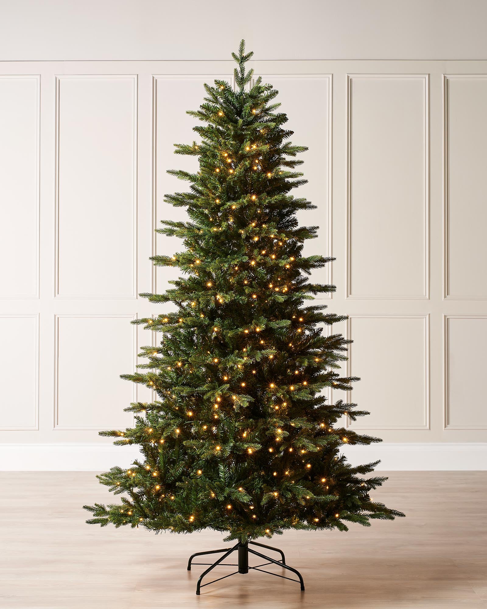 Pre-lit Himalayan fir Christmas tree with realistic green branches and warm white LED lights, displayed against a plain background. Designed for easy assembly with mixed realistic tips and built-in multi-setting lighting controller.