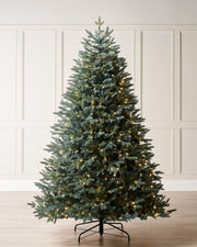 Pre-lit Blue Mixed Pine Christmas tree with lifelike mixed tips and hinged branches for easy setup. Features dual LED warm white and white lights with multi-function memory controller, displayed against a neutral background.