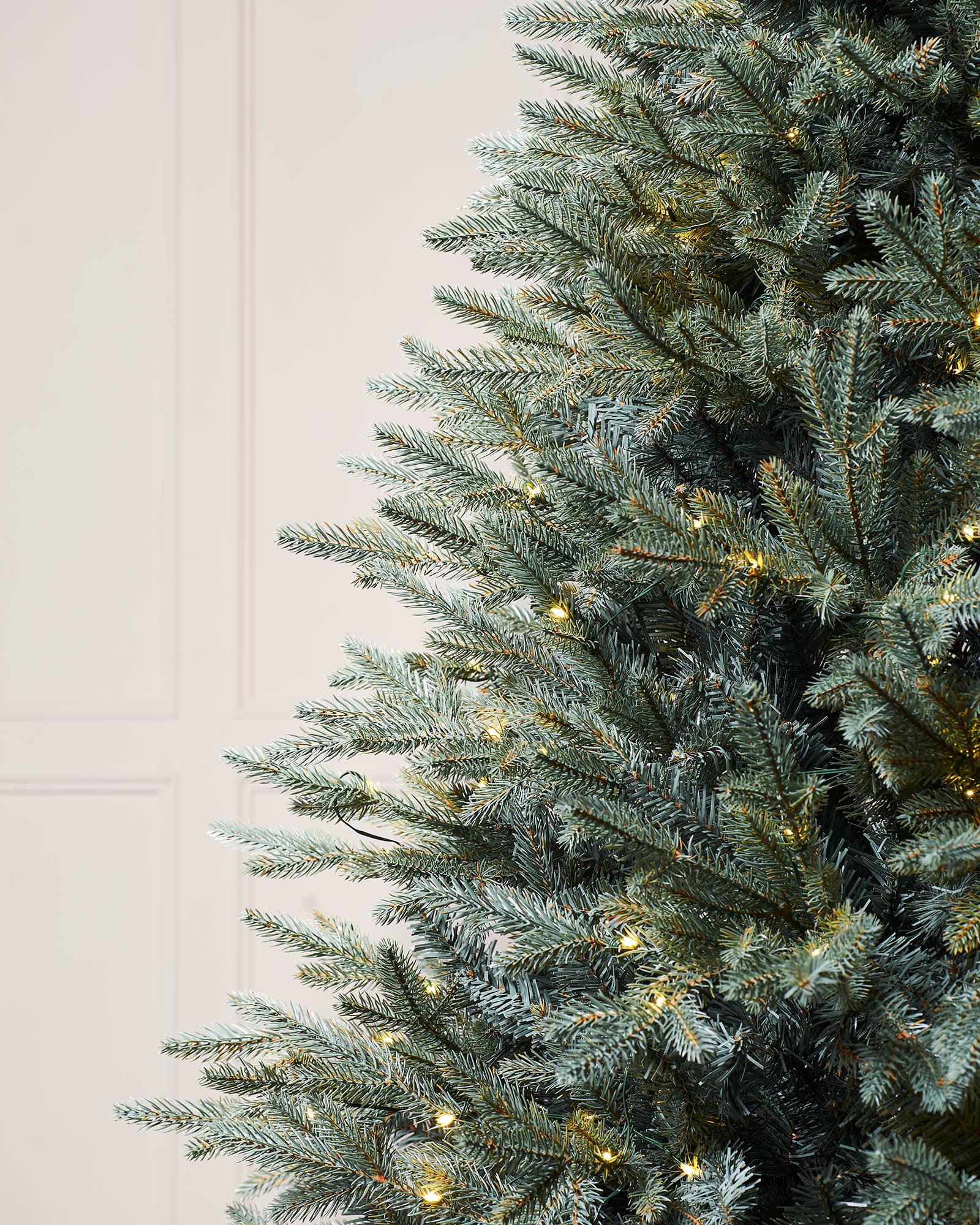 Pre-lit Blue Mixed Pine Christmas tree with lifelike mixed tips and hinged branches for easy setup. Features dual LED warm white and white lights with multi-function memory controller, displayed against a neutral background.