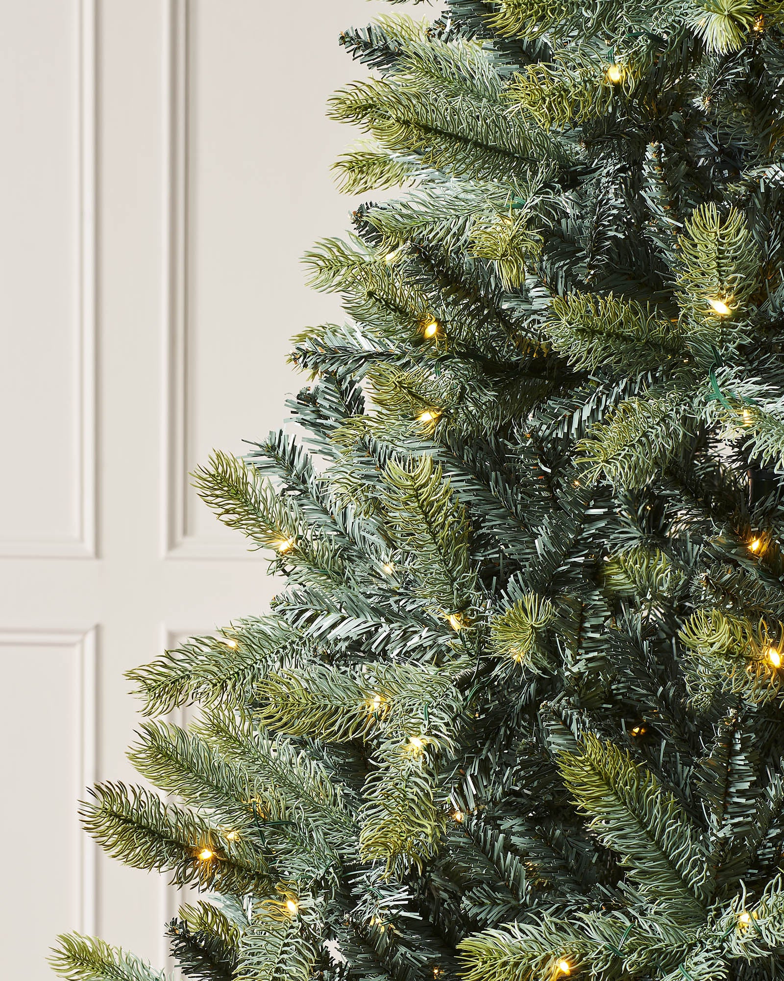 Pre-lit mixed pine artificial Christmas tree with dual LED lights in warm white and multicolour, displayed against a plain background."