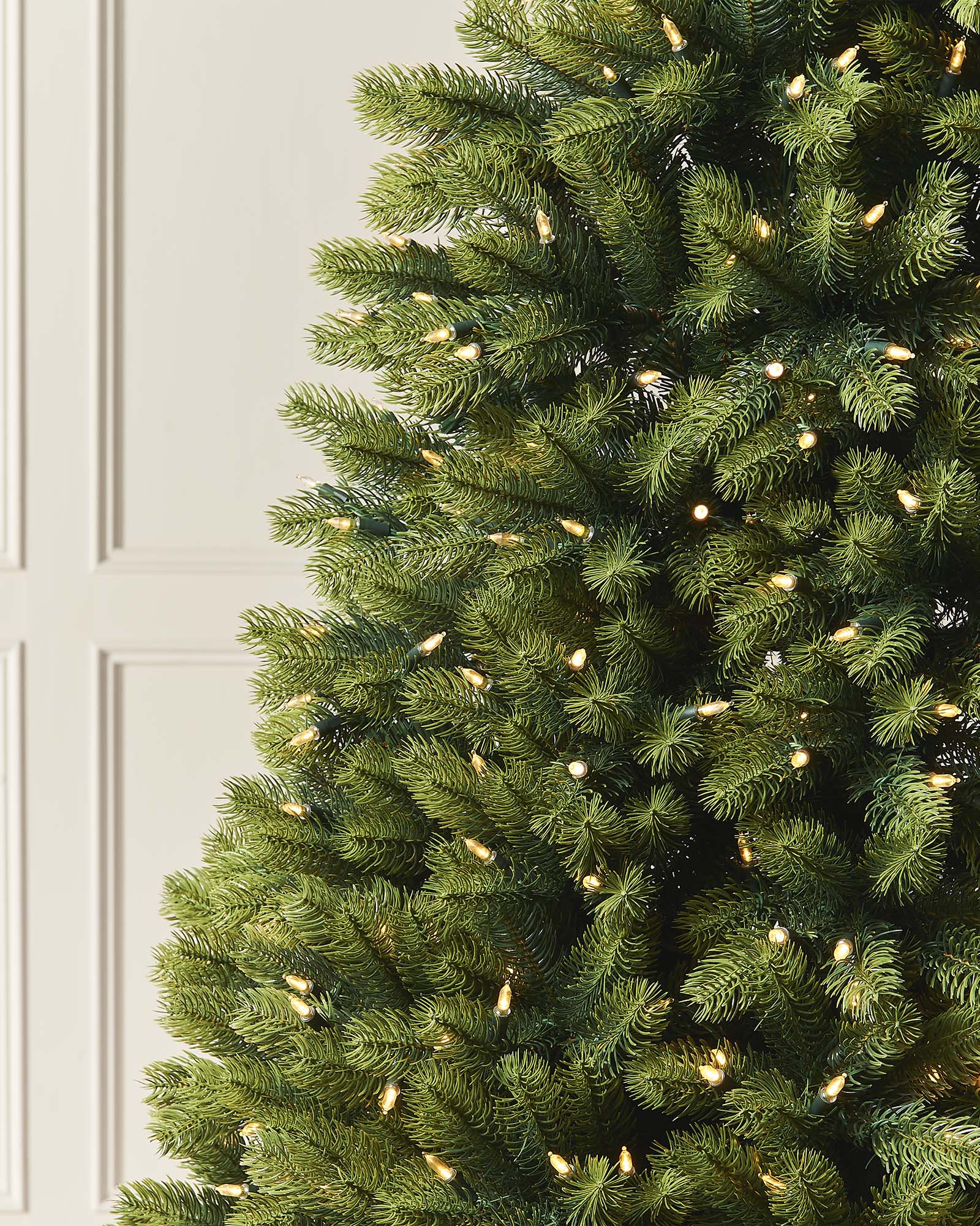 A 5-foot pre-lit mixed pine half Christmas tree with metal stand.