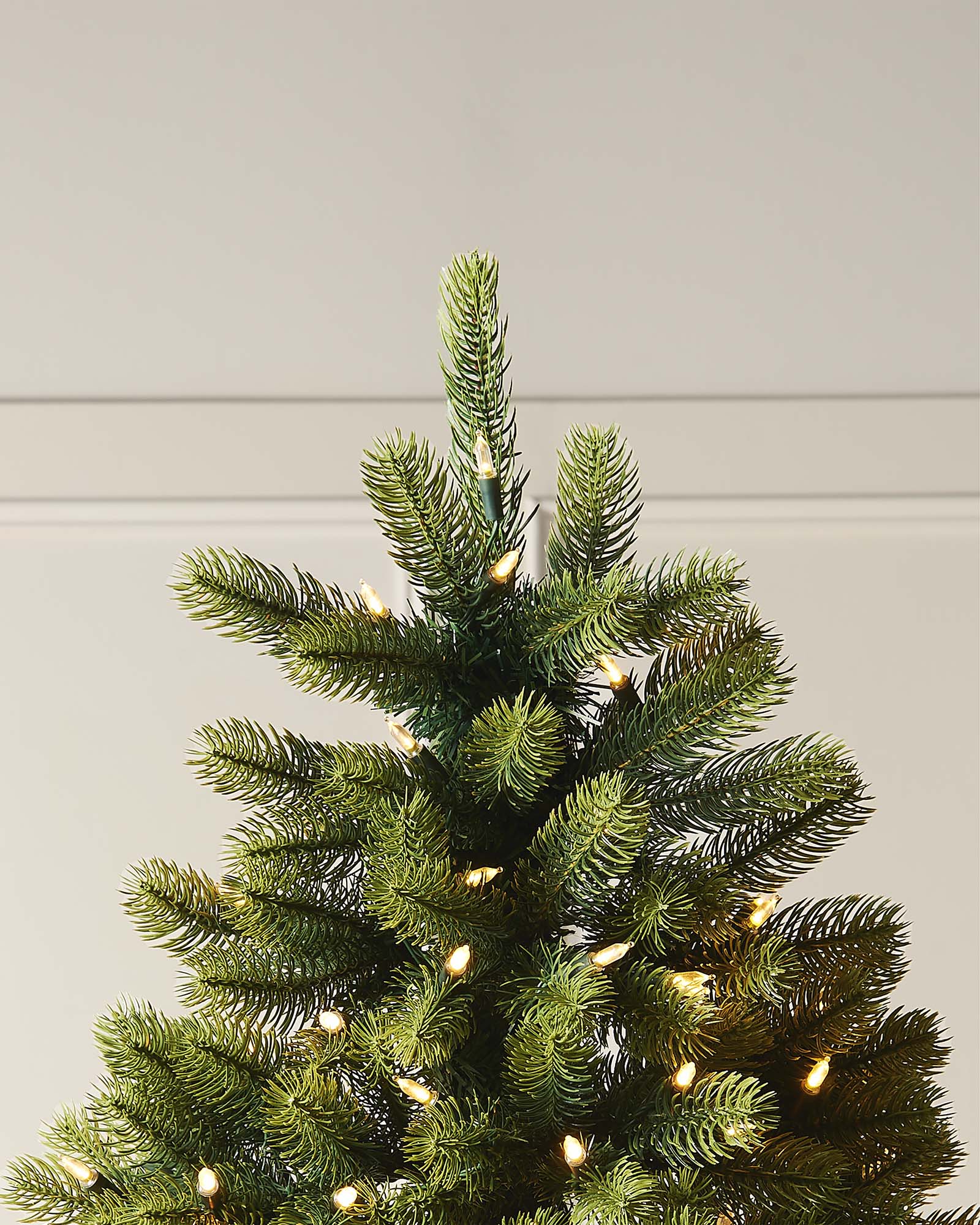 A 5-foot pre-lit mixed pine half Christmas tree with metal stand.