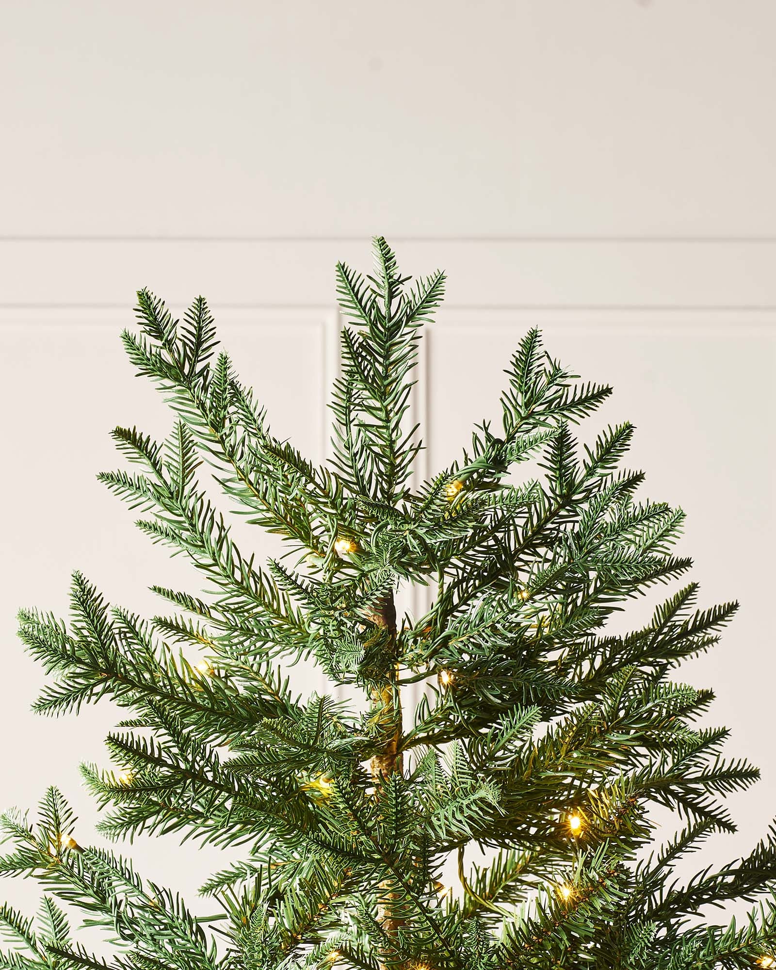 5-foot pre-lit mixed pine Christmas tree with natural bark trunk and dual LED lights in warm white and multicolour, displayed indoors against a neutral background.