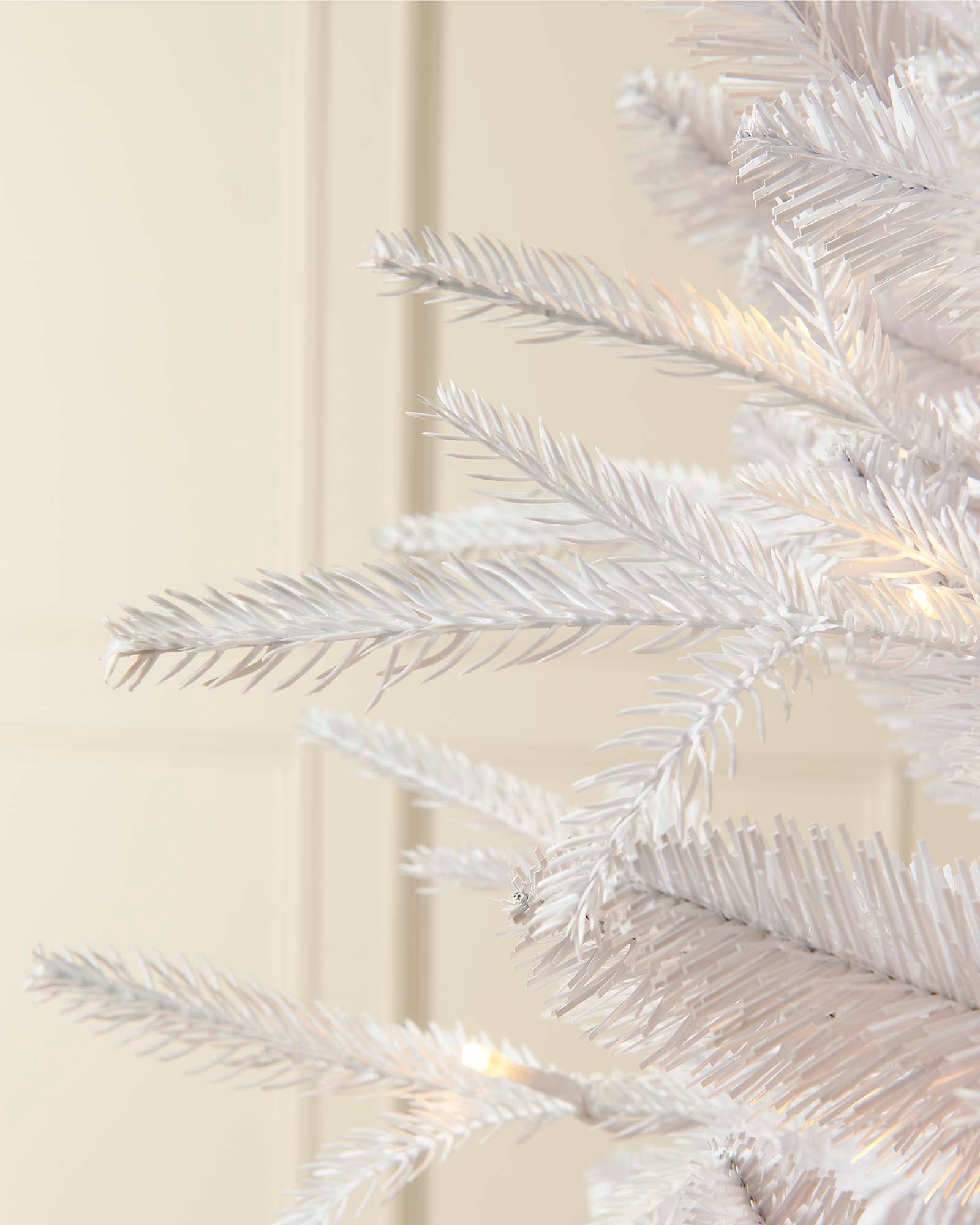 12-foot pre-lit white mixed pine Christmas tree with warm white LED lights, decorated and standing against a neutral wall with a white metal stand.