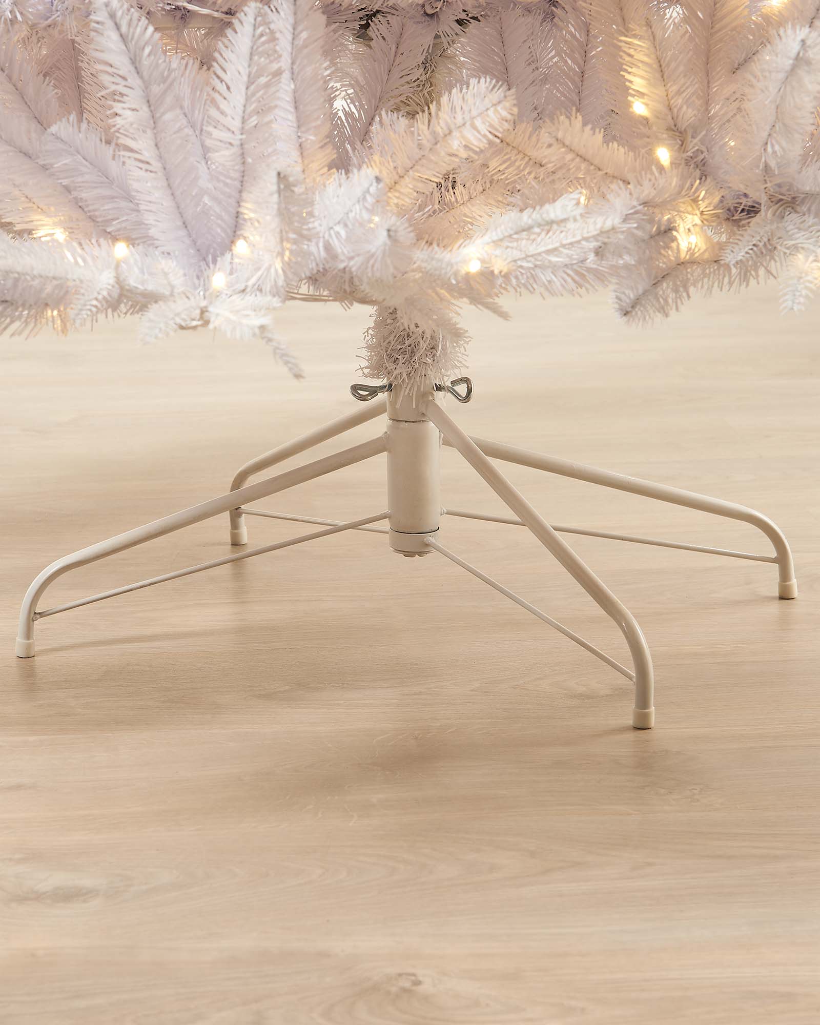 12-foot pre-lit white mixed pine Christmas tree with warm white LED lights, decorated and standing against a neutral wall with a white metal stand.
